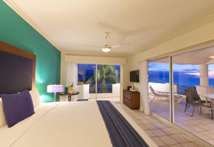 Crown Paradise Golden Adults Only gay-friendly hotel room. Balcony view, ocean, bed, and modern decor. All-inclusive resort for gay men.