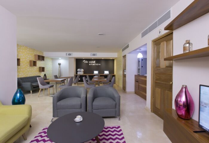 Crown Paradise Golden Adults Only work station. Gay-friendly hotel all-inclusive amenities: computers, printer, sofas, and coffee.