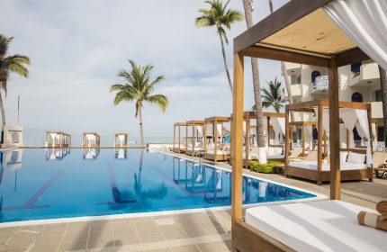 Crown Paradise Golden All Inclusive Adults Only gay-friendly hotel pool with cabanas, palm trees, and ocean view. Ideal for gay travel.
