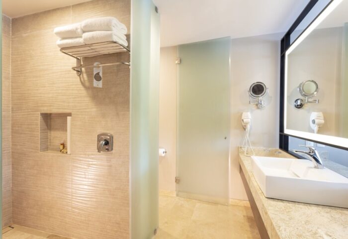 Crown Paradise Golden All Inclusive Adults Only gay-friendly hotel bathroom. Shower, sink, and mirror in a modern, clean design.