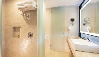 Crown Paradise Golden All Inclusive Adults Only gay-friendly hotel bathroom. Shower, sink, and mirror in a modern, clean design.