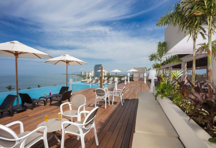 Crown Paradise Golden All Inclusive Adults Only gay-friendly hotel pool deck. Ocean view, lounge chairs, and umbrellas.