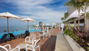Crown Paradise Golden All Inclusive Adults Only gay-friendly hotel pool deck. Ocean view, lounge chairs, and umbrellas.