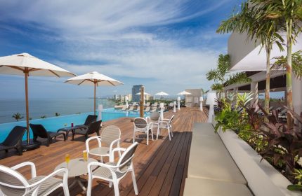 Crown Paradise Golden All Inclusive Adults Only gay-friendly hotel pool deck. Ocean view, lounge chairs, and umbrellas.