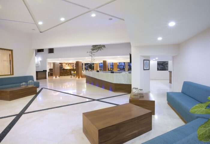 Crown Paradise Golden All Inclusive Adults Only lobby. Gay-friendly hotel interior with modern design, seating area, and reception desk.