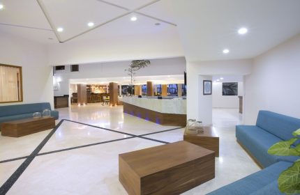 Crown Paradise Golden All Inclusive Adults Only lobby. Gay-friendly hotel interior with modern design, seating area, and reception desk.