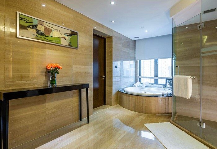 Crowne Plaza Shanghai gay-friendly hotel bathroom. Features a modern design, a large tub, and a glass-enclosed shower. Noah's Square hotel.