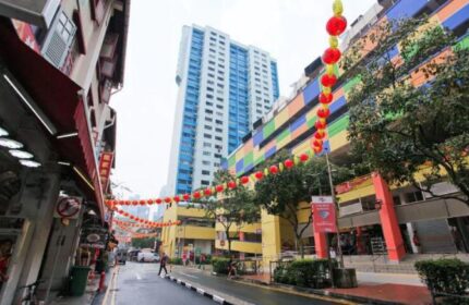Street view of Chinatown, Singapore, near Cube Boutique Capsule Hotel. Red lanterns decorate the street. Gay-friendly travel destination.