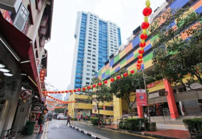 Street view of Chinatown, Singapore, near Cube Boutique Capsule Hotel. Red lanterns decorate the street. Gay-friendly travel destination.