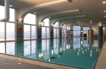 Indoor pool at the gay-friendly Dan Tel Aviv Hotel. Large windows, tiled floor, life preservers. A relaxing space for gay travelers.