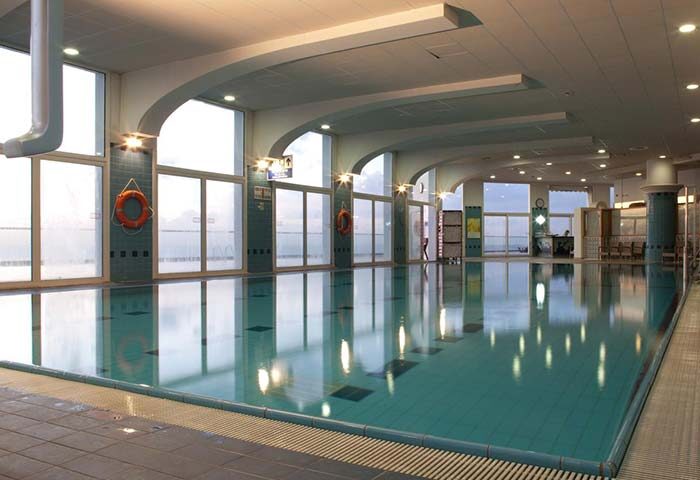 Indoor pool at the gay-friendly Dan Tel Aviv Hotel. Large windows, tiled floor, life preservers. A relaxing space for gay travelers.