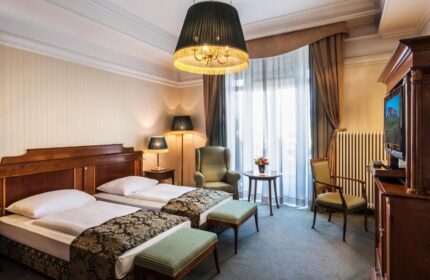 Danubius Hotel Gellert gay-friendly room. Two twin beds, sitting area, and a TV. A great choice for gay travelers in Budapest, Hungary.