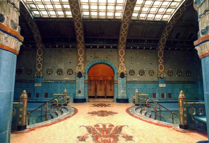 Interior of Danubius Hotel Gellert, a gay-friendly hotel in Budapest. Art Nouveau architecture with blue tile and mosaic floors. Thermal bath detail.