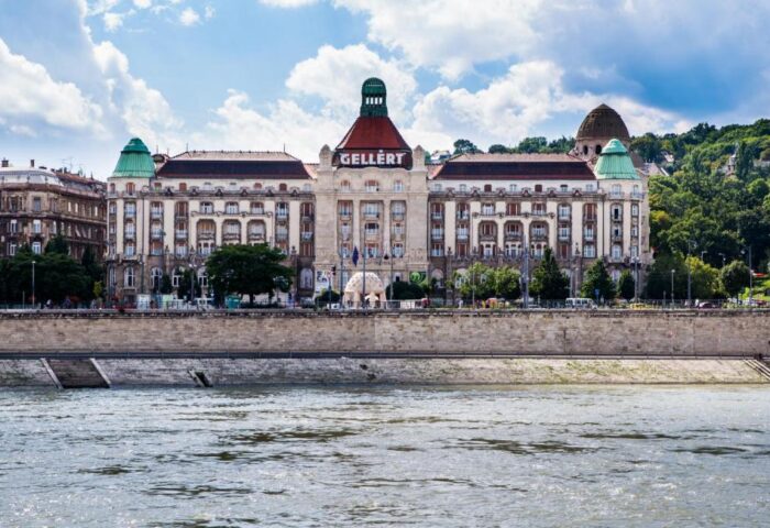 Danubius Hotel Gellert, a gay-friendly hotel in Budapest. The Gellert Spa hotel is seen from across the Danube River. Gay travel advice.