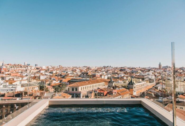 Dear Hotel Madrid rooftop pool view. Gay-friendly hotel with city skyline. Madrid travel for gay men. Luxury accommodation.