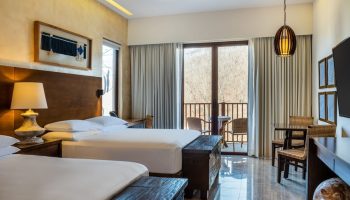 Delta Hotels by Marriott Riviera Nayarit All-Inclusive gay-friendly hotel room. Two beds, balcony, table and chairs.