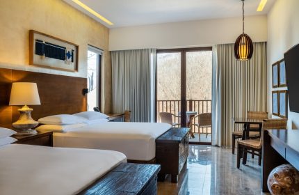 Delta Hotels by Marriott Riviera Nayarit All-Inclusive gay-friendly hotel room. Two beds, balcony, table and chairs.