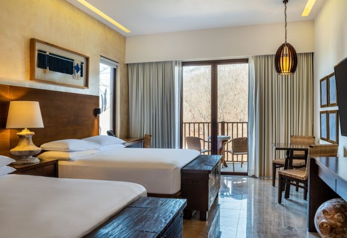 Delta Hotels by Marriott Riviera Nayarit All-Inclusive gay-friendly hotel room. Two beds, balcony, table and chairs.