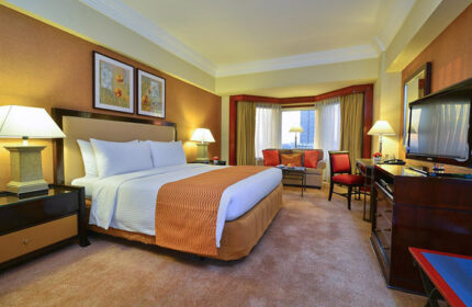 Gay-friendly Diamond Hotel room. Luxury suite with king bed, sitting area, and city view. A comfortable and welcoming space for gay travelers.