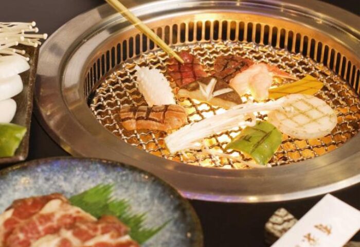 Diamond Hotel: BBQ grill with meat, seafood, and vegetables. Gay-friendly hotel dining experience. Close-up of delicious food.