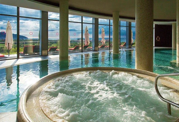 Indoor pool and jacuzzi at Dolce by Wyndham Sitges, a gay-friendly hotel. Relax in style with ocean views. Perfect for gay travel.