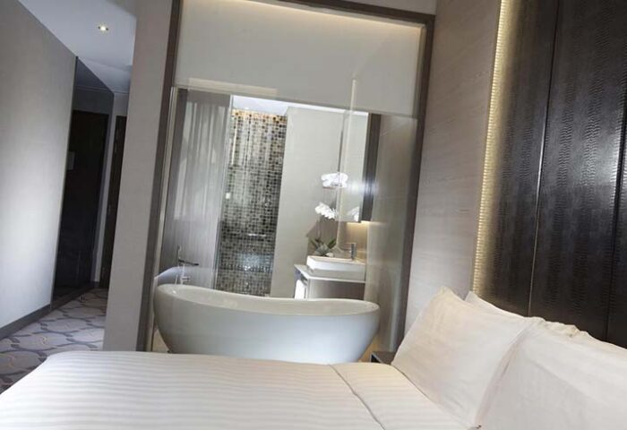 Dorsett Singapore gay-friendly hotel room. Modern design with bathtub view from the bed. Gay travel in Singapore.
