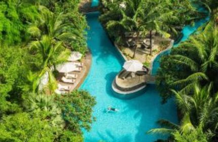 Aerial view of DoubleTree by Hilton Hotel Jakarta Diponegoro's pool. Lush greenery surrounds the gay-friendly hotel's outdoor oasis.