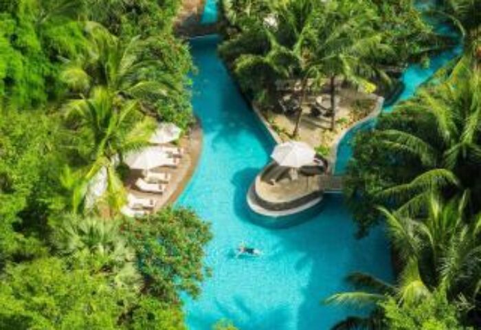 Aerial view of DoubleTree by Hilton Hotel Jakarta Diponegoro's pool. Lush greenery surrounds the gay-friendly hotel's outdoor oasis.