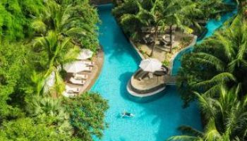 Aerial view of DoubleTree by Hilton Hotel Jakarta Diponegoro's pool. Lush greenery surrounds the gay-friendly hotel's outdoor oasis.