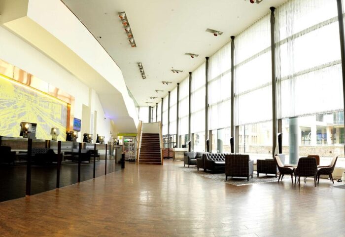 DoubleTree by Hilton Hotel Manchester-Piccadilly lobby. Gay-friendly hotel with modern design, seating areas, and large windows. Ideal for gay travelers.