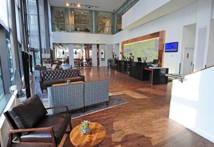 DoubleTree by Hilton Hotel Manchester-Piccadilly lobby. Gay-friendly hotel with modern design, wood floors, and comfortable seating areas.