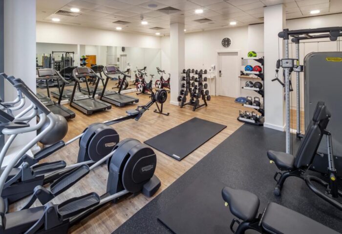 Gym at DoubleTree by Hilton Hotel Manchester-Piccadilly. Fitness equipment includes treadmills, elliptical machines, weights, and benches.
