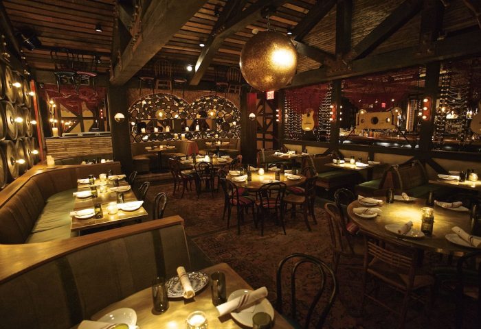 Dream Downtown Hotel's gay-friendly restaurant. Rustic interior with barrel accents, warm lighting, and cozy booths. Fine dining experience.