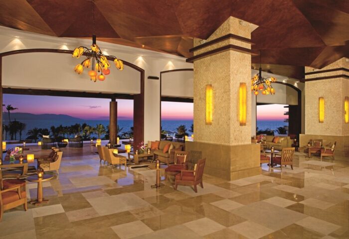 Dreams Vallarta Bay Resort & Spa lobby at sunset. Gay-friendly, all-inclusive hotel with ocean views. Ideal for gay travel.