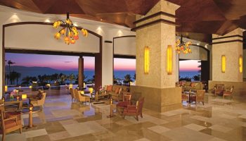 Dreams Vallarta Bay Resort & Spa lobby at sunset. Gay-friendly, all-inclusive hotel with ocean views. Ideal for gay travel.