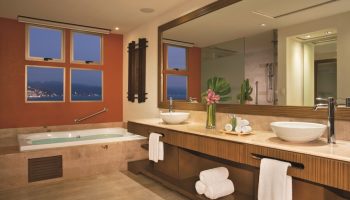 Dreams Vallarta Bay Resort & Spa bathroom. All-inclusive, gay-friendly hotel with jacuzzi tub and ocean view. Luxury travel for gay men.