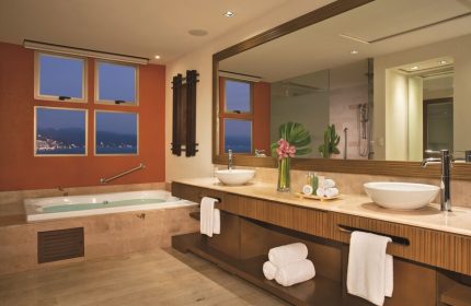 Dreams Vallarta Bay Resort & Spa bathroom. All-inclusive, gay-friendly hotel with jacuzzi tub and ocean view. Luxury travel for gay men.