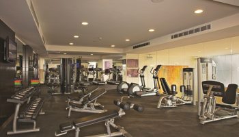 Gym at Dreams Vallarta Bay Resort & Spa, an all-inclusive, gay-friendly hotel. Fitness equipment includes weights, treadmills, and elliptical machines.