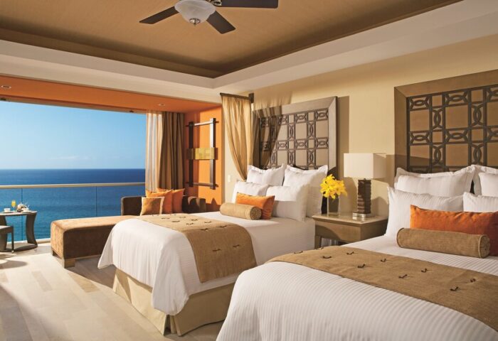Dreams Vallarta Bay Resort & Spa all-inclusive gay-friendly hotel: Ocean view suite with two beds and balcony overlooking the sea.