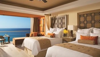 Dreams Vallarta Bay Resort & Spa all-inclusive gay-friendly hotel: Ocean view suite with two beds and balcony overlooking the sea.