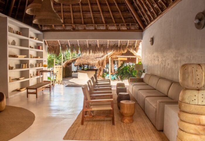 Dune Boutique Hotel lobby at the party zone. Gay-friendly hotel with rustic design, thatched roof, and beach view. Perfect for gay men's travel.