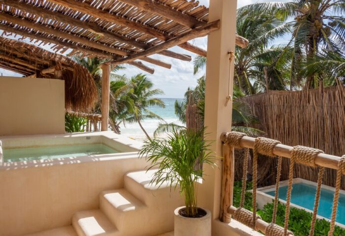 Dune Boutique Hotel view. Gay-friendly hotel at the party zone with a pool, beach, and palm trees. Ideal for gay men's travel.