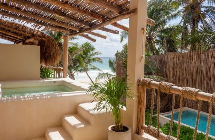 Dune Boutique Hotel view. Gay-friendly hotel at the party zone with a pool, beach, and palm trees. Ideal for gay men's travel.