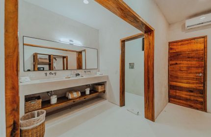 Dune Boutique Hotel bathroom. Modern design, wood accents, large mirror, double sinks. Gay-friendly hotel in the party zone.