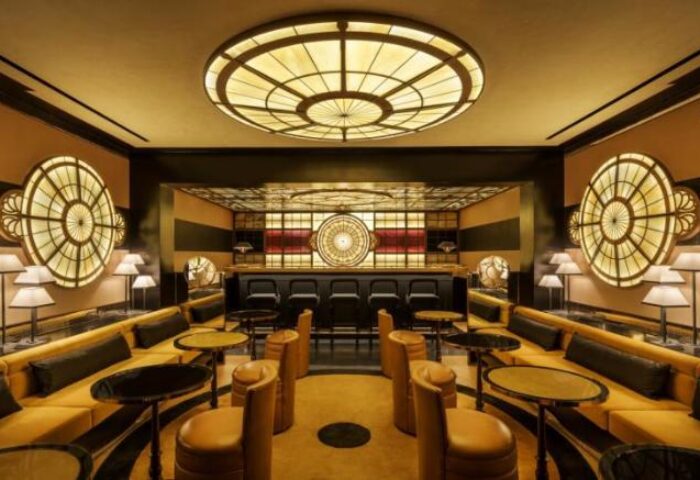 Interior of Duxton Reserve Singapore, a gay-friendly hotel. Stylish bar, circular lights, and seating. Autograph Collection hotel design.