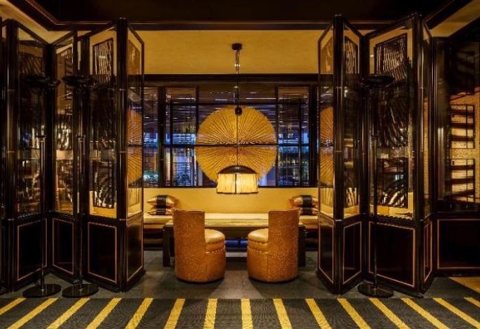 Duxton Reserve Singapore Autograph Collection's gay-friendly hotel interior. Stylish seating area with folding screens and unique decor.