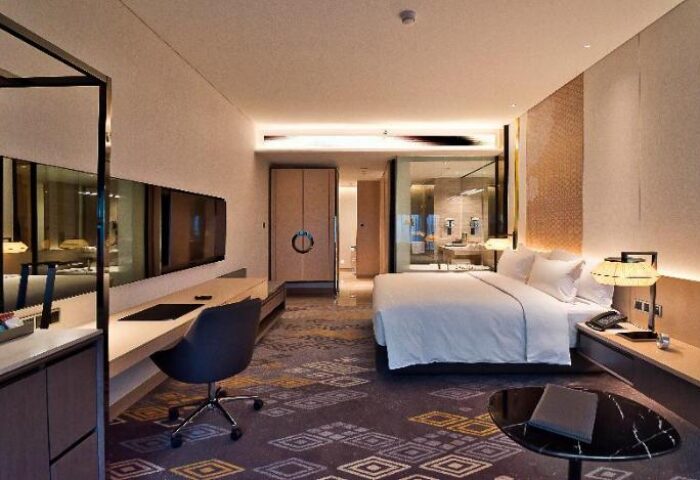 EQ Kuala Lumpur hotel room. Modern interior, king bed, desk, and bathroom. Gay-friendly hotel for gay men travelers.
