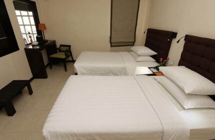 East Hotel room with twin beds. Gay-friendly hotel featuring clean, modern design. Comfortable stay for gay travelers.