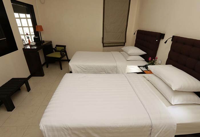 East Hotel room with twin beds. Gay-friendly hotel featuring clean, modern design. Comfortable stay for gay travelers.