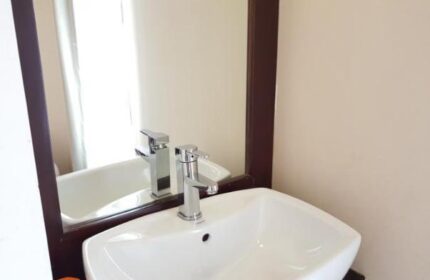 Bathroom sink and mirror at East Hotel, a gay-friendly hotel. Modern fixtures and clean design for gay travelers' comfort.